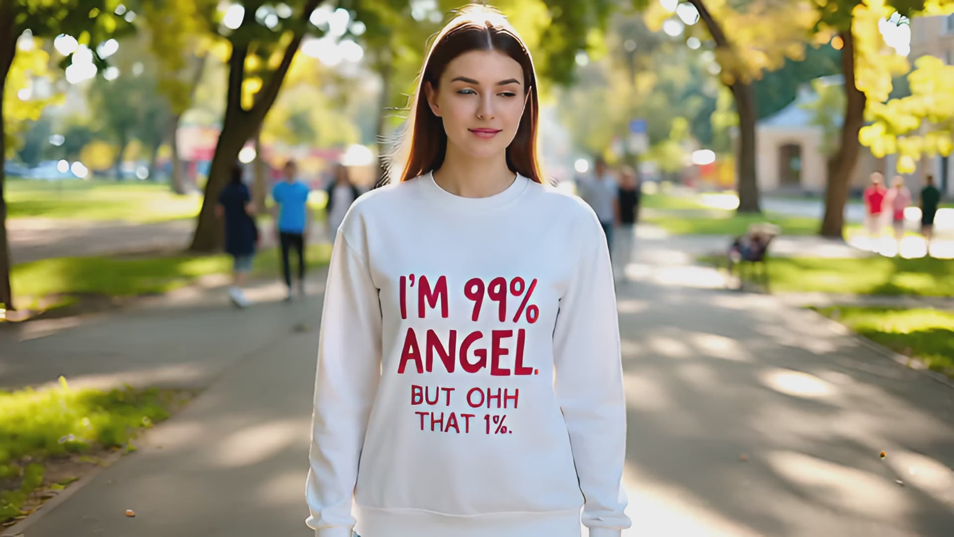 Load video: Young Lady walking in the park wearing a white t-shirt saying I&#39;m 99% Angel, But Ohh THAT  1%.